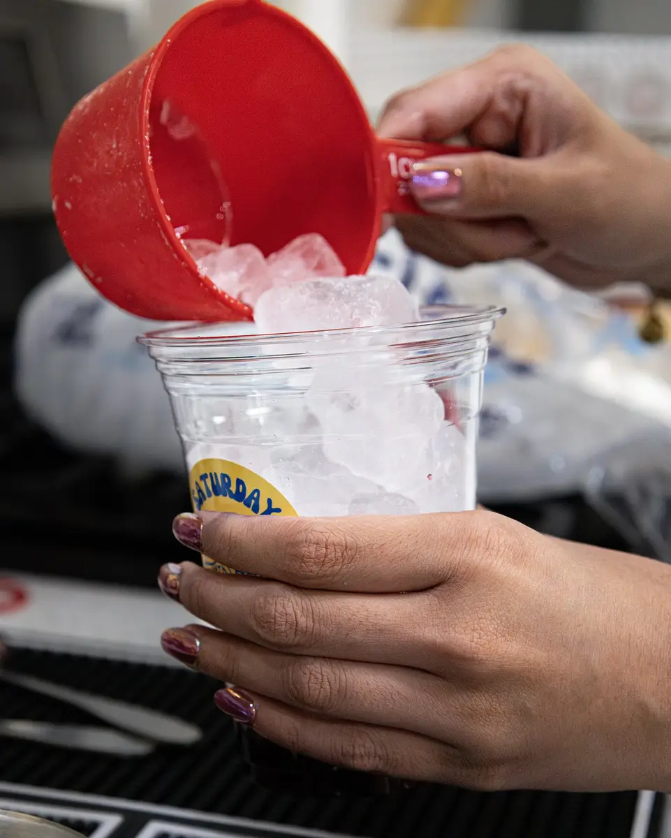 Pouring a fresh raspberry lemonade